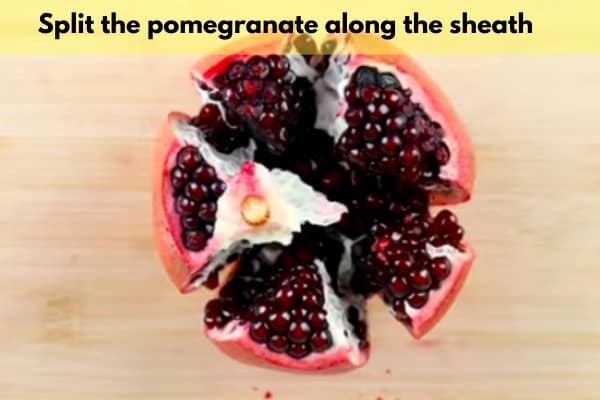 split the pomegranate along the sheath